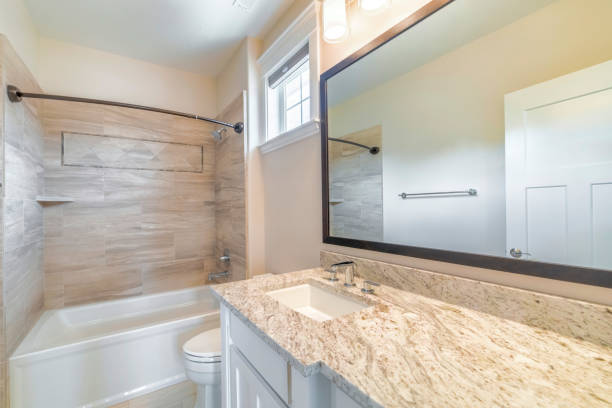 istock Mirror, a sink, and a bath in a bathroom 1463744036