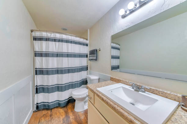 istock Mirror, a sink, and a bath with closed curtains in a bathroom 1463744452