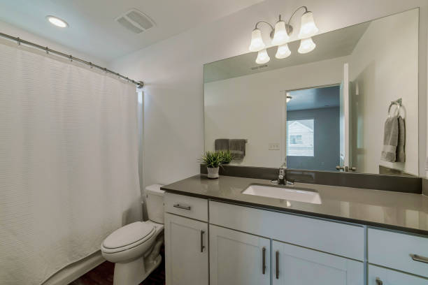 istock Mirror, a sink, and a bath with closed curtains in a bathroom 1463744767