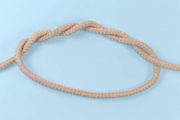 istock Rope knot Threefold overhand knot on a blue background 1463746733