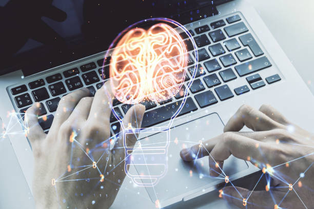 istock Double exposure of creative light bulb hologram with human brain and with hands typing on laptop on background, idea and brainstorming concept 1463749692