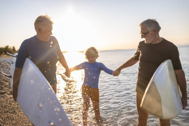 istock Active Grandparents with grandson at the beach 1463751556