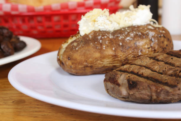 istock Sirloin steak with baked potato and fresh rolls 1463752829
