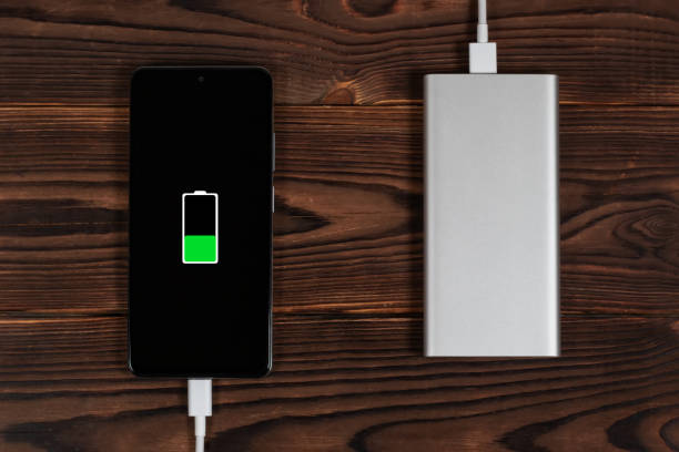 istock Powerbank and charge smartphone on wooden table 1463754155