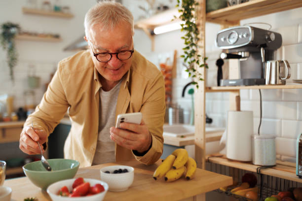 istock Senior man text messaging at his domestic kitchen 1463754249