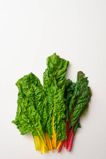 istock Bunch of rainbow swiss chard leaves on beige stone table. 1463756459
