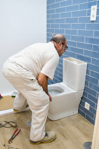 istock Senior plumber installer installing toilet. 1463756627
