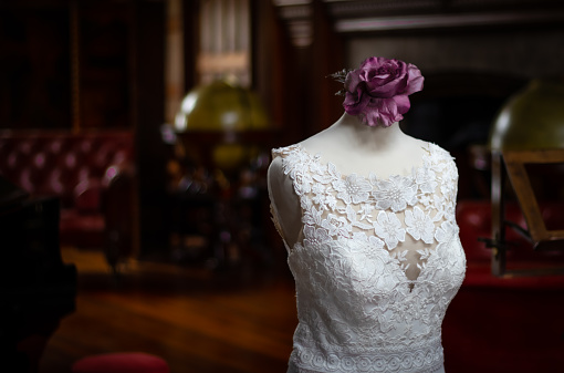 A selective focus shot of a beautiful wedding dress on a mannequin