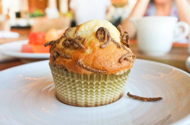 A closeup shot of a cupcake on a plate for breakfast