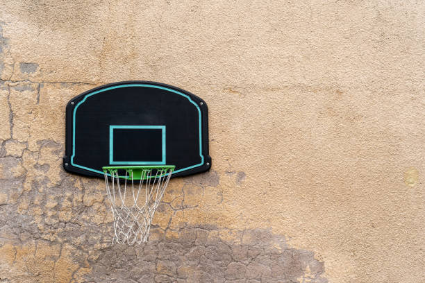 Basketball ring mounted on the old concrete wall