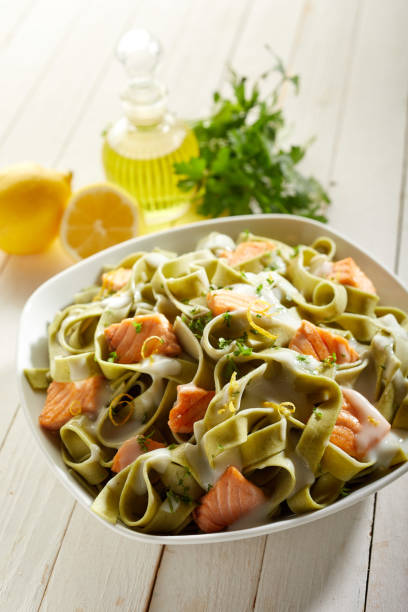 istock Portion of delicious green pasta with salmon pieces 1463764788