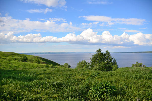 istock green hill with green grass and tree and Volga river with cloudscape on background in dawn 1463765613