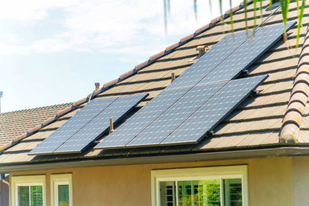 istock Brown tile roof with solar panels on it under a bright sky on a sunny day 1463765617