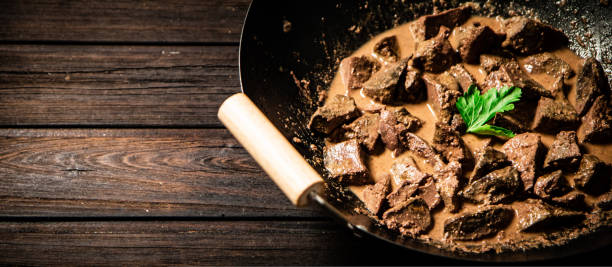 Cooked liver in a saucepan.
