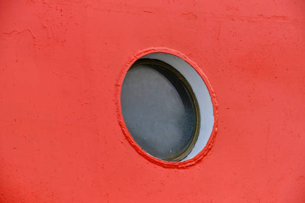 istock Ship round porthole red background ship hull paint. 1463765902