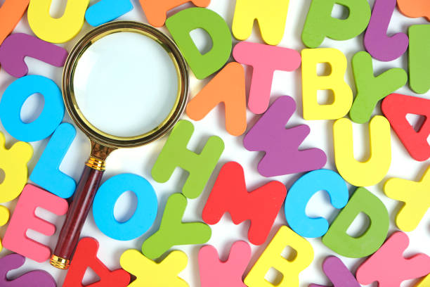 istock Magnifying glass and bright multicolored letters English alphabet. 1463766298