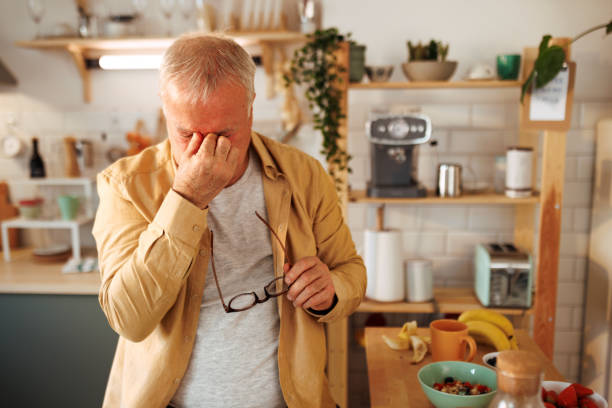 istock Senior man experiencing headache in a domestic kitchen 1463766451
