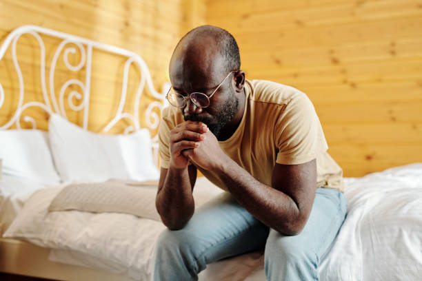 istock Young depressed man keeping clenched hands by his face 1463767629