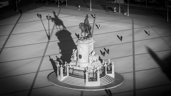 Black and white aerial view of Praca do Comercio square with people silhouettes, and shadows