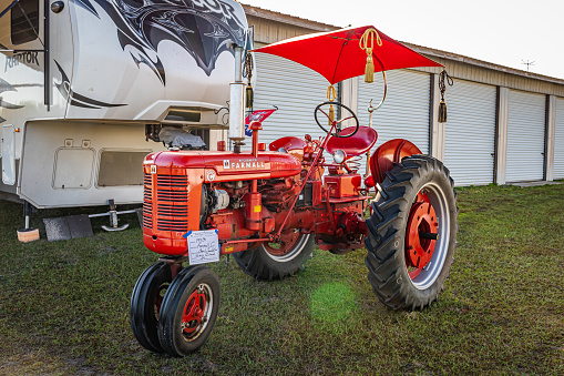 Fort Meade, FL - February 22, 2022: High perspective front corner view of a 1953 International Harvester Farmall Super C Tractorat at a local tractor show.