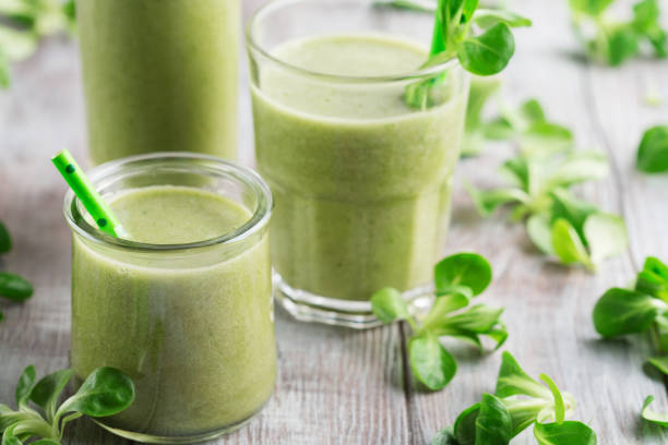 istock Detox Diet Concept: Green Spinach Smoothie on White Wooden Table. 1463768003