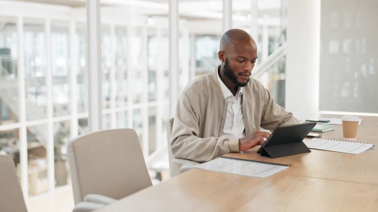 Businessman thinking, working with tablet and typing email or internet research for business project in conference room. Black man, employee and writing with technology, online and folder with ideas