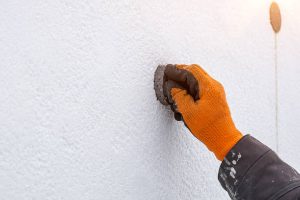 istock A worker insulates a house with polystyrene, sealing a crack in the house 1463772653