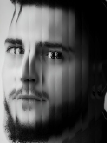 Abstract portrait of a bearded man made with random cutouts. Deformed portrait of a young man. Man face closeup with glitch effect. Black and white portrait.