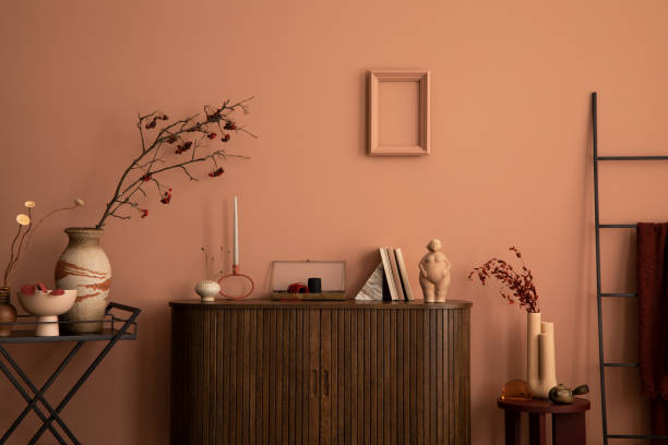 istock Warm and cozy living room interior with frame, wooden commode, ladder, round coffee table vase with dried flowers, sculpture, ornament on the wall and personal accessories. Home decor. Template. 1463775764