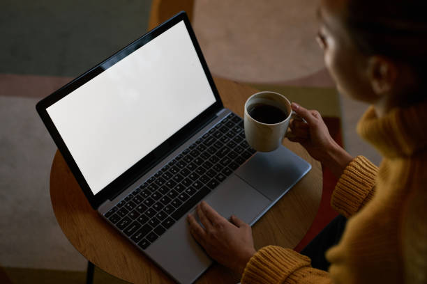 istock view at young woman using laptop with blank screen mockup 1463776448