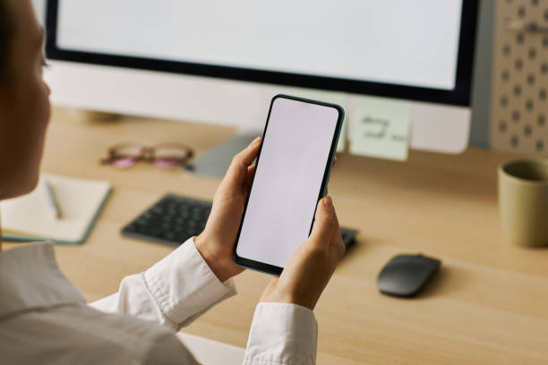 istock Closeup young woman holding smartphone with white screen mockup 1463776738