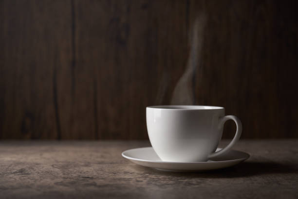 istock Cup of coffee with grains on wooden background 1463776898