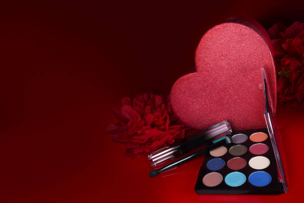 istock Cosmetics on a red background. There are lipstick, eyeshadow, powder, blush, eyeliner, 1463779247