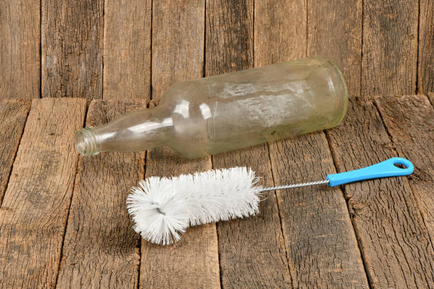 Wire brush for cleaning bottles isolated on dark wood background. High resolution photo. Full depth of field.