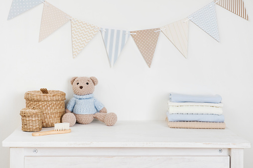 Kids room decorated wall background and sideboard with baby goods