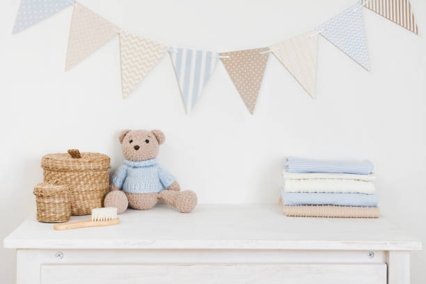 Kids room decorated wall background and sideboard with baby goods stock photo