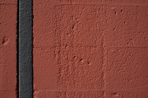 Textured red color brick wall background closeup