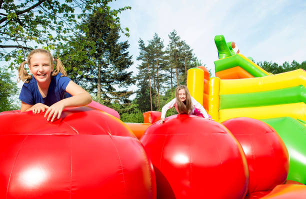 istock Happy Girls on Jupming Castle Outside 1463791292