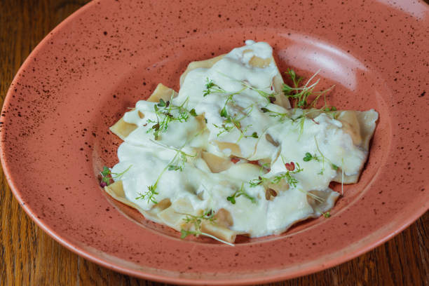 istock ravioli with sour cream and sprinkled with fresh herbs in a plate 1463792206