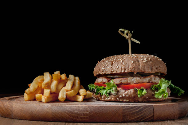 istock burger with a latch on a wooden board on a black background 1463792447