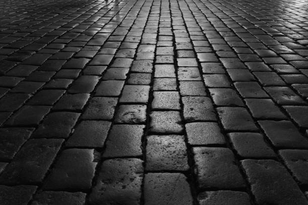 istock Cobblestones with night lights. Black and white color. 1463795360