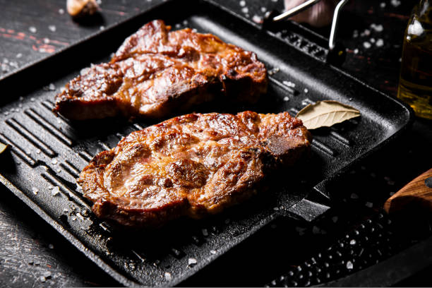 istock Grilled pork steak in a frying pan. 1463800188