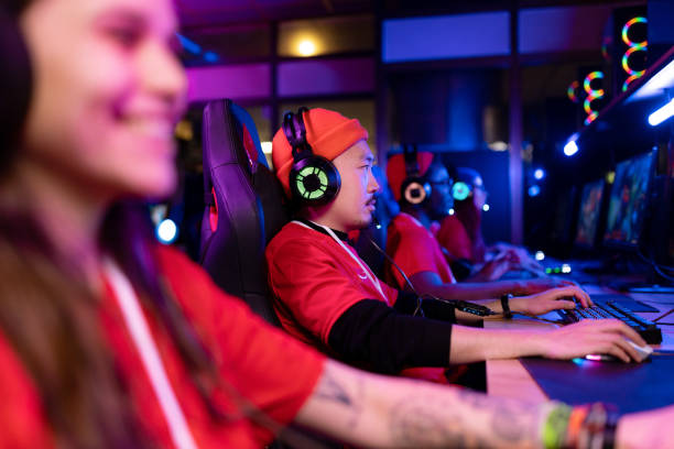 istock Professional gamers playing video games on computers at gaming club. 1463802618