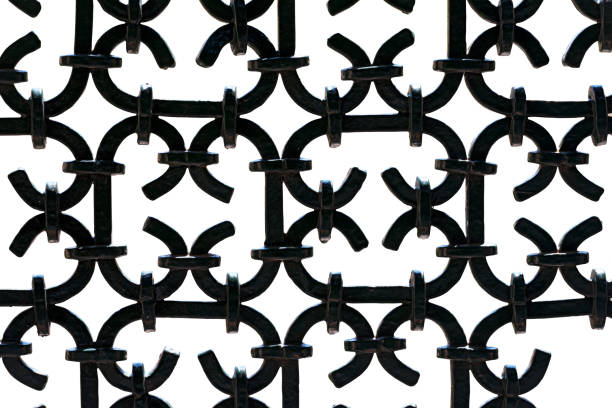 Close-up of a black painted wrought iron fence, isolated on white background, photography, Italy, Europe.
