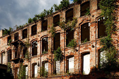 Red brick facade of an abandoned factory