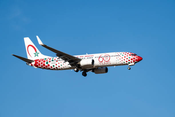 royal air maroc airplane, decorated with stars and colored hexagons, with the landing gear lowered. - wheel airplane landing air vehicle imagens e fotografias de stock