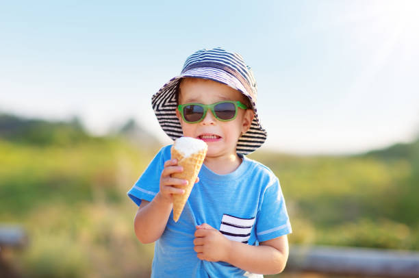 istock Unhappy boy tasted ice cream in a cone in nature 1463810377