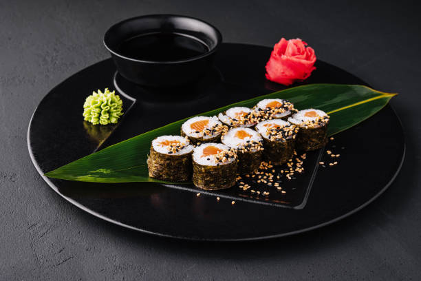 istock Sushi Rolls Set with Salmon on black plate 1463817836