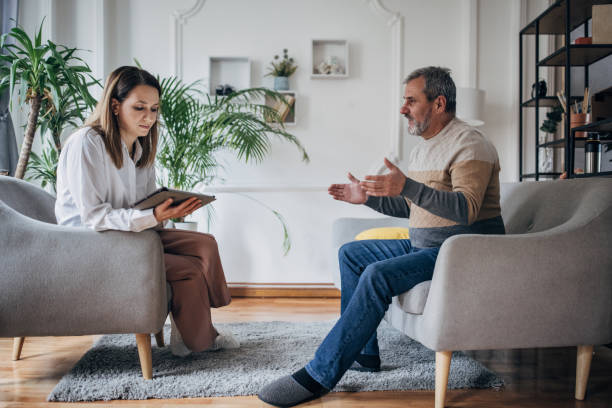 istock Psychotherapy, young woman doctor talking to an older man 1463817841