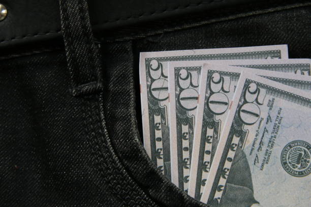 istock Money in jeans pocket, creative concept. 1463819231